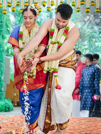 A candid shot from an Iyengari wedding, where the bride's beautifully stained hands are part of the sacred rituals.