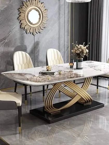 This dining table makes a bold statement with its intricate, interwoven golden base and a beautiful marble top, perfect for a luxury dining room.