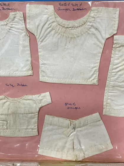 A collection of miniature traditional Indian garments like the 'jubba' and 'knickers' from my mother's journal. Her attention to detail was remarkable.