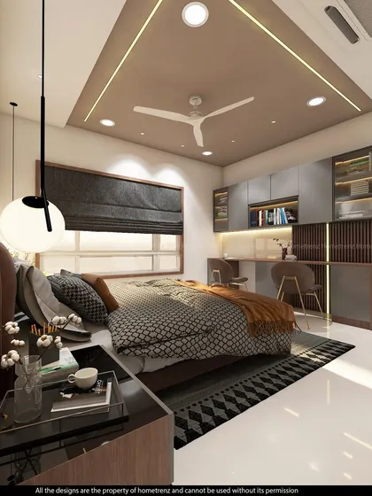 A kids' bedroom with a built-in dual-desk study area. The grey and wood-tone cabinets are complemented by warm lighting.