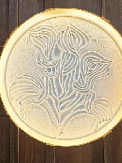 We take pride in adding handcrafted touches to our projects. This backlit wall art, made from MDF and putty, is an example of how we turn a simple white wall into a piece of art, adding texture and soft ambient light.