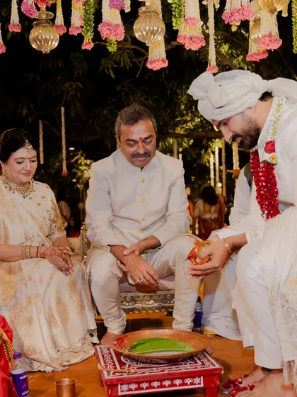 We believe in treating every family member with the same special attention. Here, the parents of the groom are seated during the wedding ceremony, looking elegant in their coordinated ivory outfits.