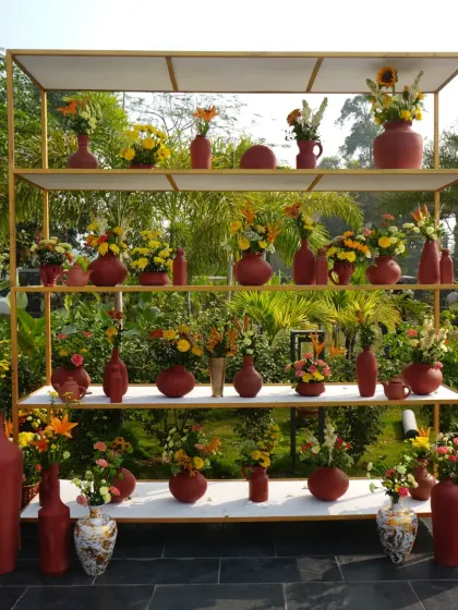 The full view of the impressive floral shelving display, creating a beautiful and functional photo backdrop or space divider.