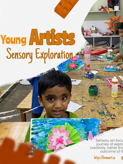 This young artist is proudly displaying his lotus flower craft. Sensory art focuses on the journey of exploration and creativity, not just the final outcome.