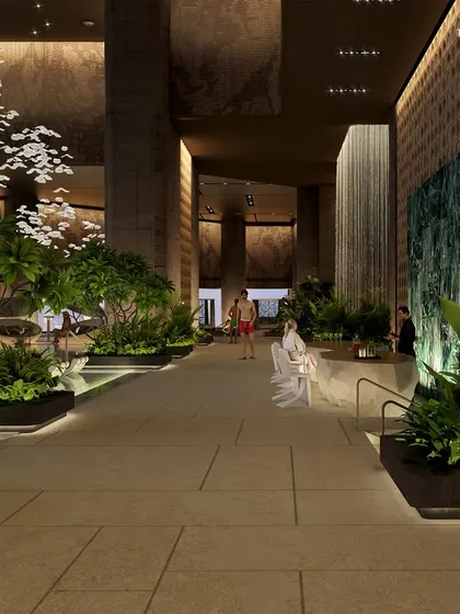 A view of the Palais Royale pool area, where a waterfall feature and verdant planters create a tropical ambiance. This serene retreat in the heart of the city is designed for balance and mindful restoration.
