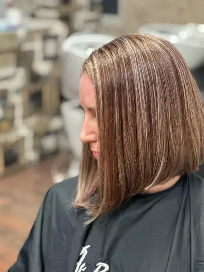 This client had red and brown box dye in her hair. I corrected it to create this smooth, ash-blonde and baby brown base with clean, fine highlights.