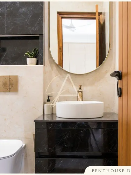 Even a small powder room can make a big statement. In this design, I contrasted black marble with a lighter-toned marble and added brushed gold fixtures for a touch of compact luxury.