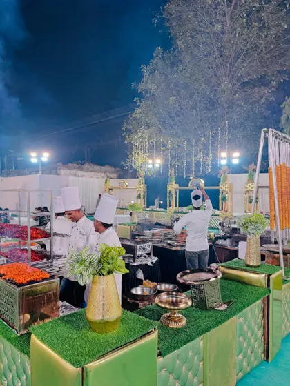 A bustling barbecue area with multiple chefs at work, showcasing our capacity to handle large crowds.