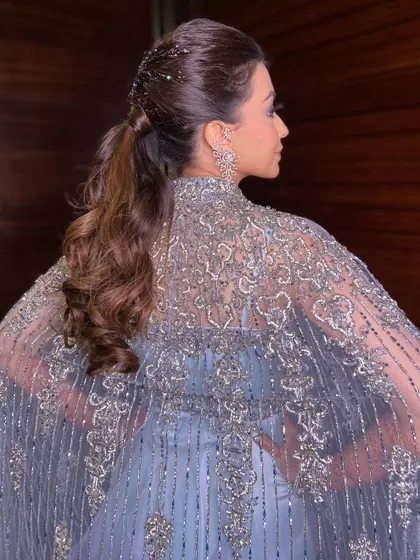 For a truly glamorous look, I added glitter to the roots of this sleek ponytail. It's a bold and fun choice for a cocktail party or reception.