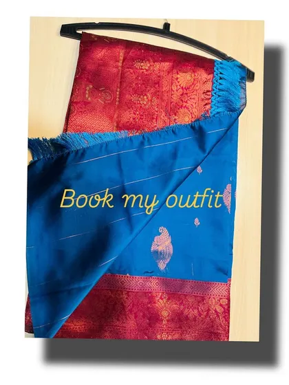 A shot of the maroon and blue silk saree, showing the rich texture of the fabric and the contrast of the blue pallu.