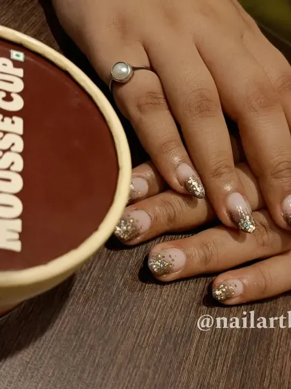Another variation of a festive glitter nail, perfect for celebrations.