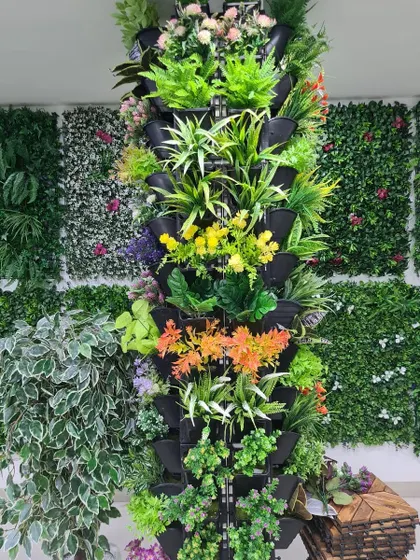This freestanding vertical tower is filled with a variety of colorful artificial plants. It's a great, movable solution for adding a floral decoration to an office, lobby, or event space.