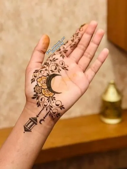 A beautiful Arabic-style design for Eid, featuring a crescent moon, a hanging lantern, and floral vines.