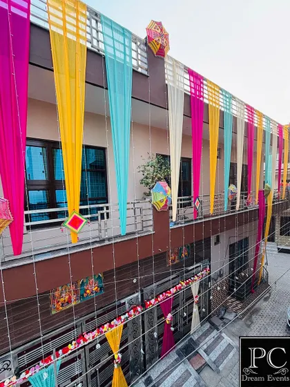This is what we call the perfect 'Shadi Vala Ghar' feeling. We transformed the entire house front with vibrant, colorful drapes and traditional hangings, creating a festive and welcoming atmosphere for a wedding celebration.
