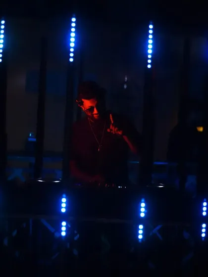A darker, silhouetted shot against the blue lights.