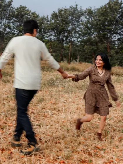 A playful moment from a pre-wedding shoot in a natural setting. The motion blur on the groom adds a dynamic feel to this happy, candid shot.