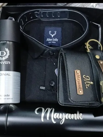 Another variation of the all-black gift hamper, featuring a personalized temperature bottle, wallet, and keychain with different charms, a shirt, and deodorant.