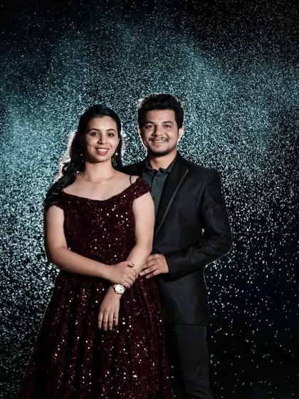 Posed against a backdrop of soft rain, this couple's portrait is full of romance. The sequined gown catches the light beautifully, creating a sparkling effect.