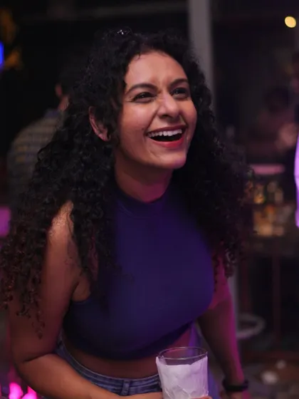 A huge smile that lights up the room. The energy is infectious.