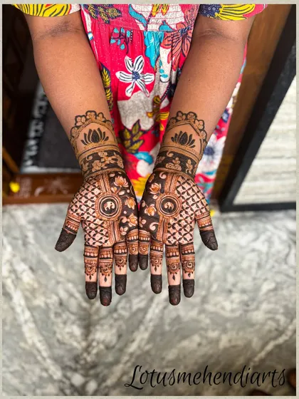 A beautiful and intricate design for a guest, featuring a central lotus with detailed finger patterns.