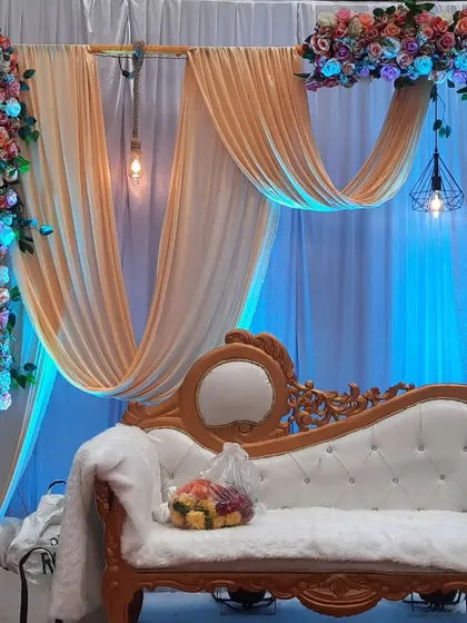 A close-up of the stage sofa and decor. I pay attention to details like the lighting fixtures and floral arrangements to ensure everything is perfect.