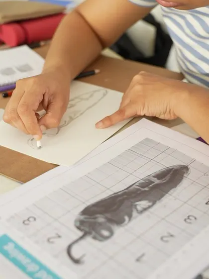A student in our CFA program uses the grid method to sketch a complex still life. This course is designed to build a solid foundation, starting with basics and progressing to more advanced projects.