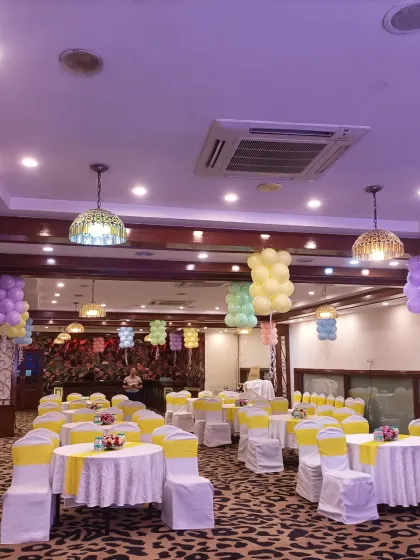 I can decorate the entire venue to match your theme. For this baby shower, I hung balloon clusters from the ceiling lights and set up the guest tables with matching yellow chair covers.