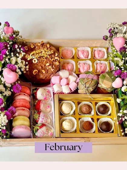 Gifting is an art, and our luxury hampers are our masterpiece. This Valentine's Day hamper was curated with love, featuring a chocolate smash heart, macarons, chocolate-dipped strawberries, and artisanal truffles, all nestled amongst fresh flowers.
