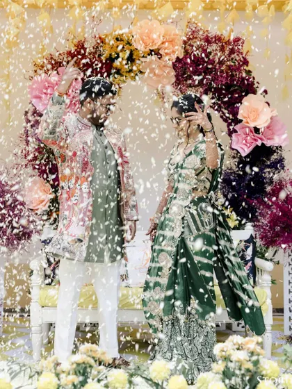 Another shot of the couple's energetic dance performance, with confetti filling the air around them.
