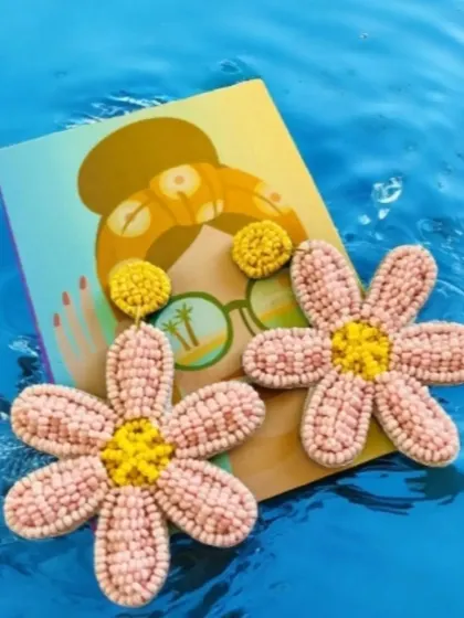 I love this shot of our pink floral earrings looking like they're floating on water. It captures their fresh, summery vibe perfectly. These are a wonderful accessory for a beach vacation or a sunny day out.