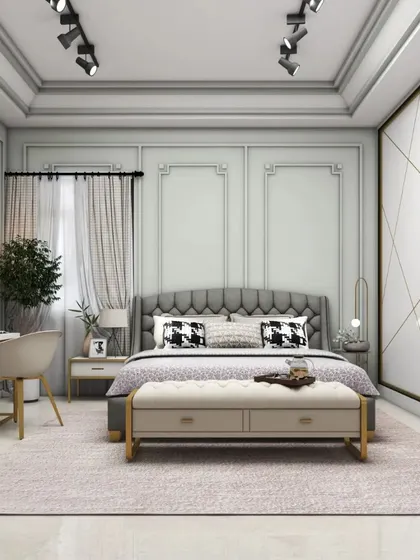 This view of the Victorian-inspired bedroom highlights the tufted headboard, elegant wall mouldings, and a dedicated study desk. The track lighting on the ceiling adds a modern touch to the classic design.