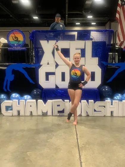 Celebrating a great score! This Xcel Gold athlete is thrilled with her performance at the regional championships.