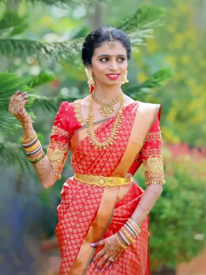 A beautiful portrait of a bride in her red wedding saree, an ideal shot for a solo page in her album.