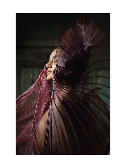 A profile shot of the same purple garment, showing how the light catches the delicate, sheer fabric. This highlights the material and craftsmanship of the piece.