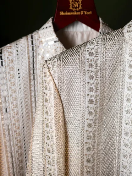A close-up of the shoulder and sleeve of our embroidered sherwanis. It highlights the years of skill passed down and perfected, reflected in every single stitch.