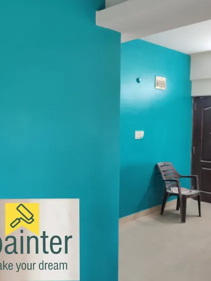 Another angle of the room painted in a vibrant turquoise, showing consistent color application even in corners.