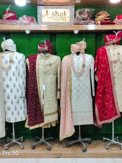 Another look at our wide range of sherwanis displayed in the store. You can see different styles, from heavily embroidered to simpler, elegant pieces, all complete with matching dupattas and turbans.