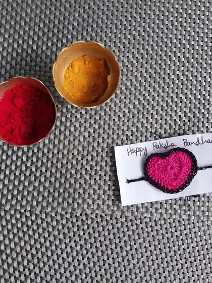 A simple and sweet heart-shaped crochet rakhi. Sometimes, the simplest designs convey the most love.