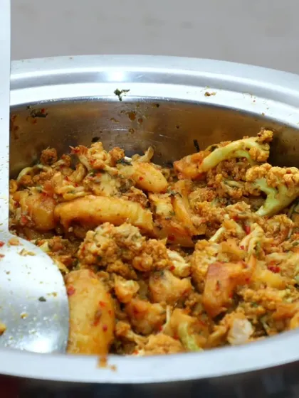 A serving bowl of Aloo Gobi, ready for the buffet line.