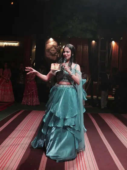 In my element as an MC on stage, wearing this gorgeous gown. It shows that I dress the part to bring glamour to any event I host.