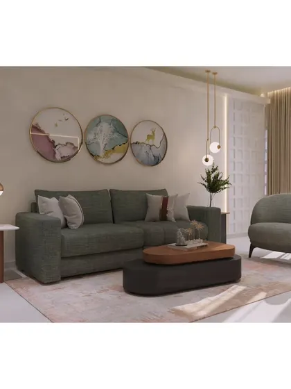 A full view of the seating arrangement, featuring a comfortable three-seater sofa and a matching accent chair. The mix of textures and art creates a welcoming and stylish environment.