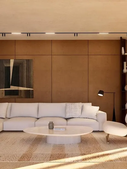 The informal living room at Kumo House features rich wood-paneled walls and a plush sectional sofa. It's a cozy, inviting space designed for relaxation and intimate family moments.