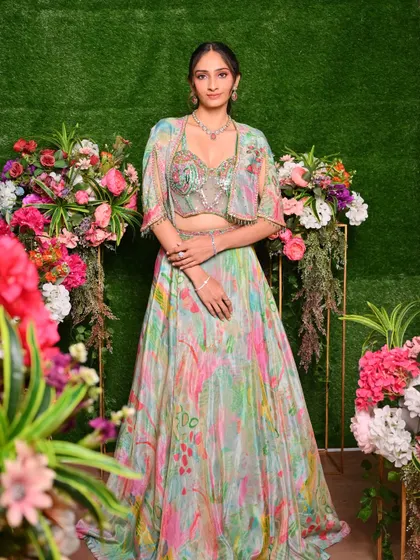 This Mehendi or Sangeet look is fresh and vibrant, with makeup tones that pick up the beautiful colors in the floral lehenga. The focus is on glowing skin and bright, happy energy.