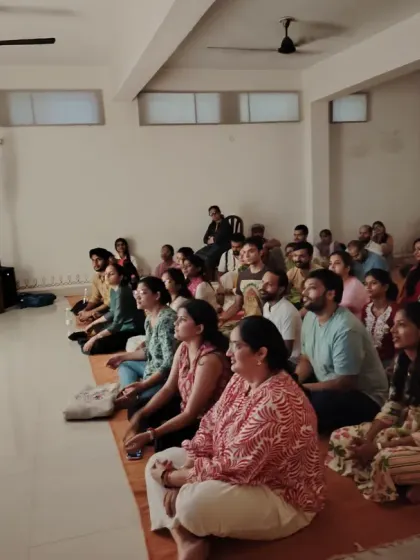A view of our Sangha, our spiritual family, gathered for the Guru Purnima celebration. The room is filled with seekers from all walks of life, sitting together in shared reverence and joy.