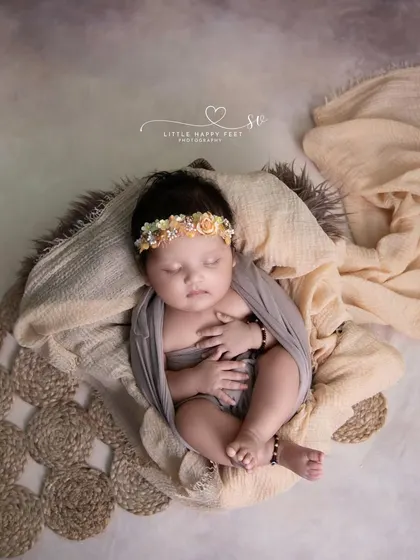 Wrapped in love. This simple, elegant portrait in neutral tones highlights the baby's beautiful features and peaceful sleep.
