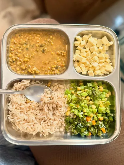 A balanced meal of brown rice, dal, sautéed French beans, and cubed cheese for an extra protein kick.