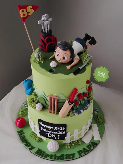 An 85th birthday cake for a keen golfer and cricketer. This two-tiered cake is decorated with handcrafted elements representing his favorite sports.