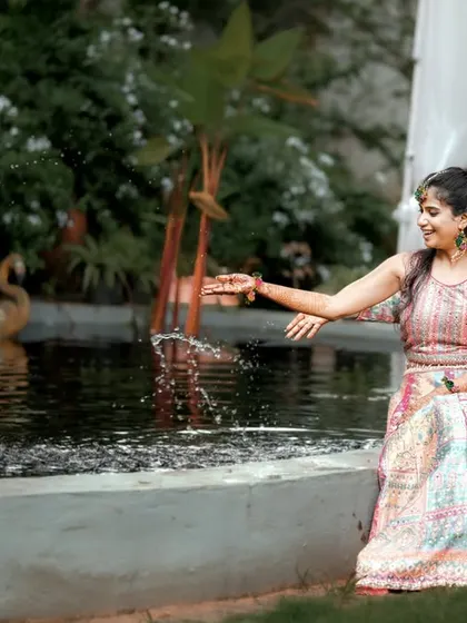 A playful moment by the water feature, capturing the couple's fun-loving spirit.