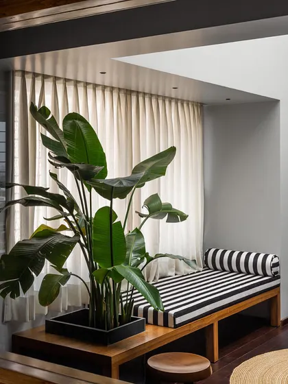 This timber bench with an integrated planter box is a piece I designed for a master bedroom lounge. It combines seating with greenery, creating a functional and peaceful element by the window.