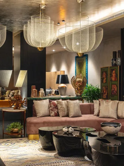 A full view of the formal living room, featured in Living Etc India. The space is a masterclass in layering, with multiple seating areas, dramatic lighting, and a rich collection of art and artifacts from around the world.
